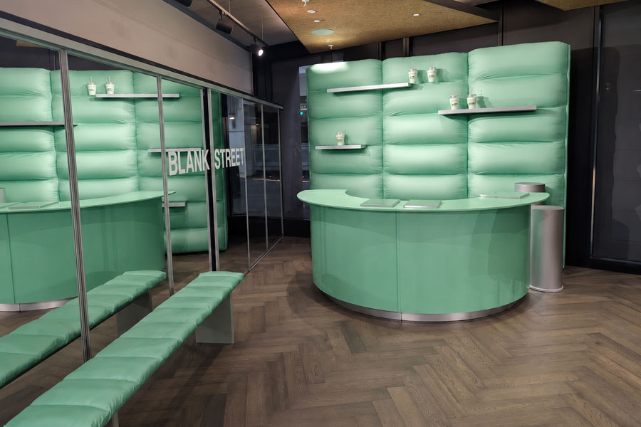 Custom-built experiential marketing installation created for Blank Street Coffee featuring branded retail counters and immersive set design.