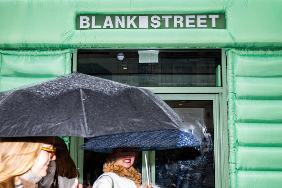 Bespoke retail brand activation entrance for Blank Street Coffee featuring puffer type set design and branded signage.