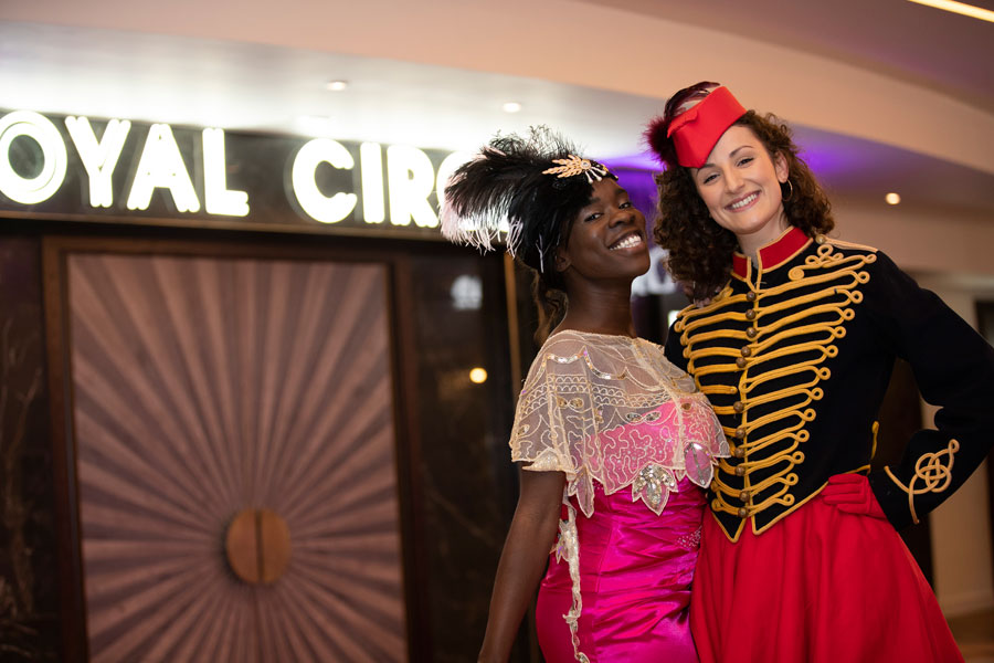 Themed entertainers greeting guests at a corporate film screening with immersive cinema entertainment.