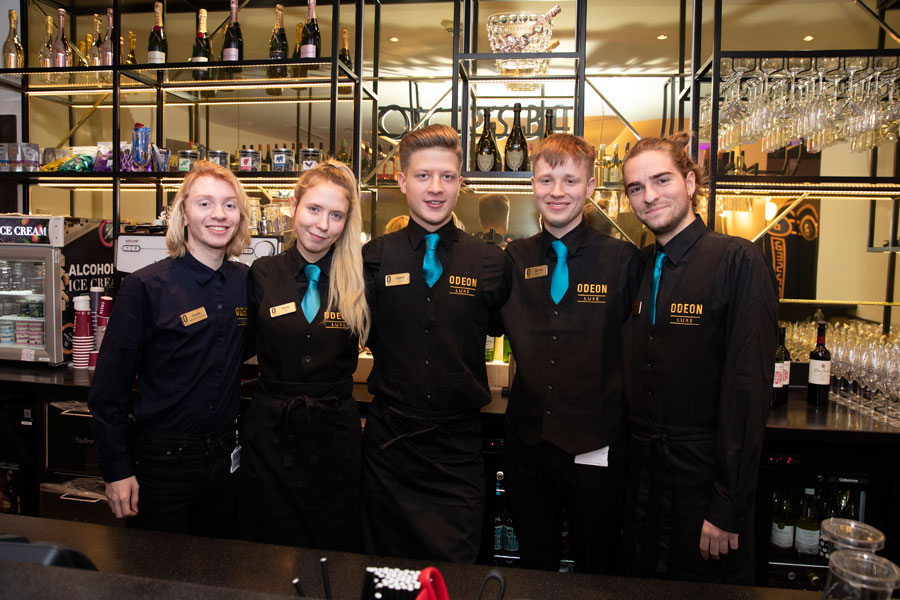 Professional event staff providing hospitality services at a corporate film screening and private cinema event.