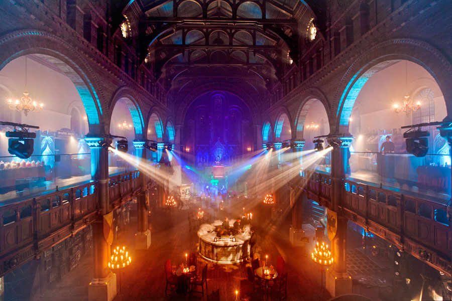 Large-scale venue transformed for a corporate film screening with immersive event production, themed lighting and branded entertainment.