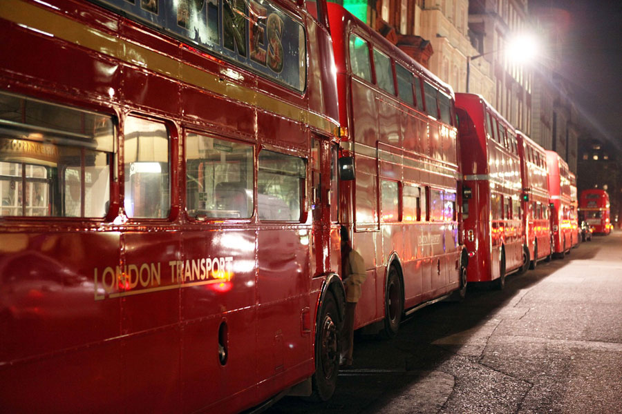 Classic London Routemaster buses transporting guests to a corporate film screening and private cinema event in London.